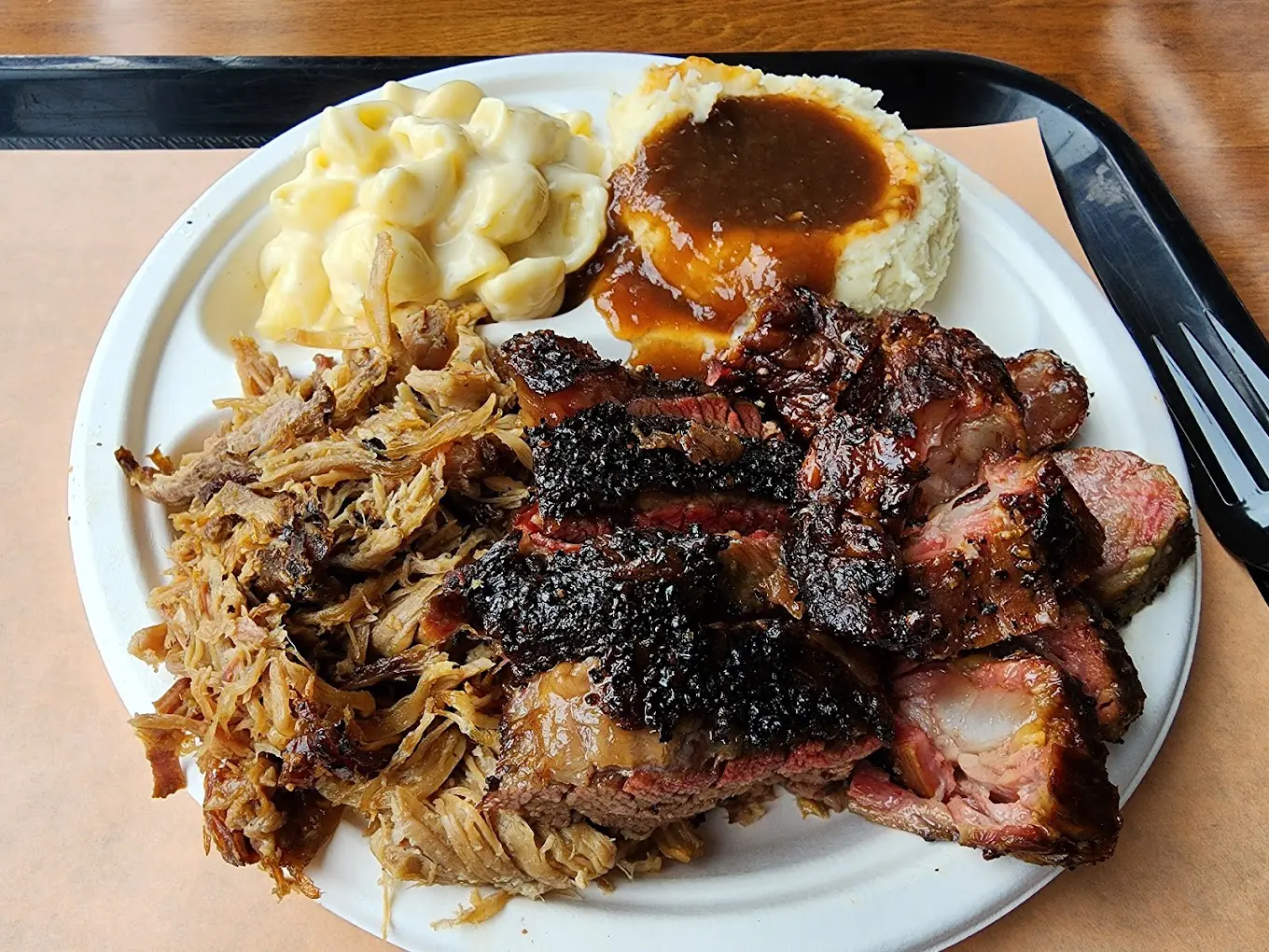 A plate of food with meat, potatoes and gravy.