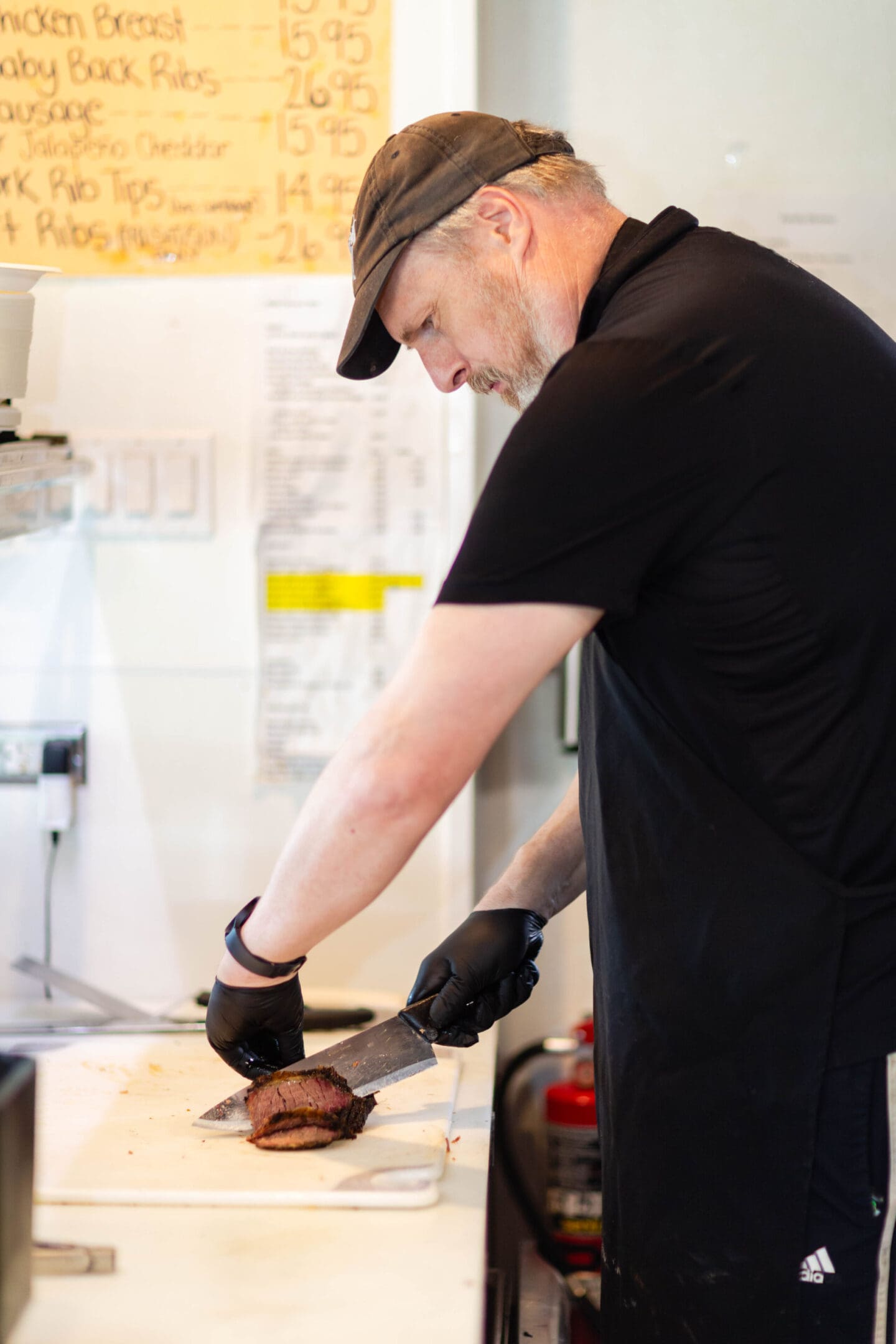 A man in black shirt holding a knife.