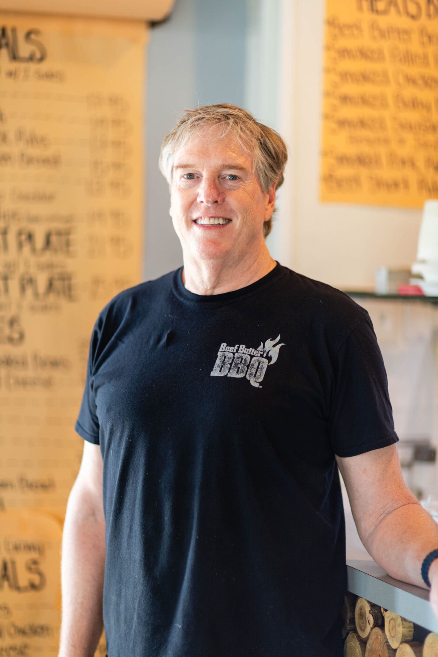 A man standing in front of a wall with writing on it.