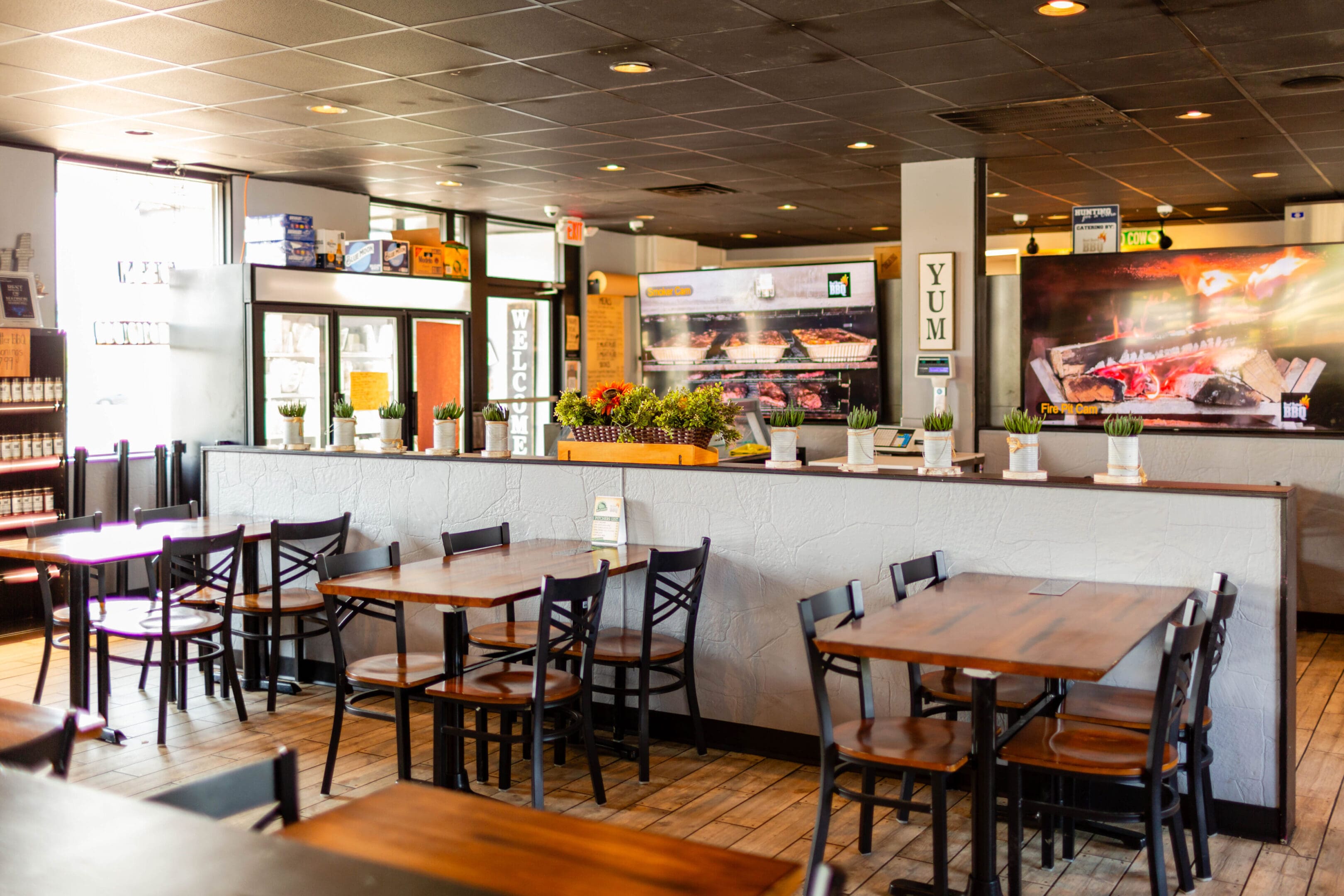 A restaurant with wooden tables and chairs in it