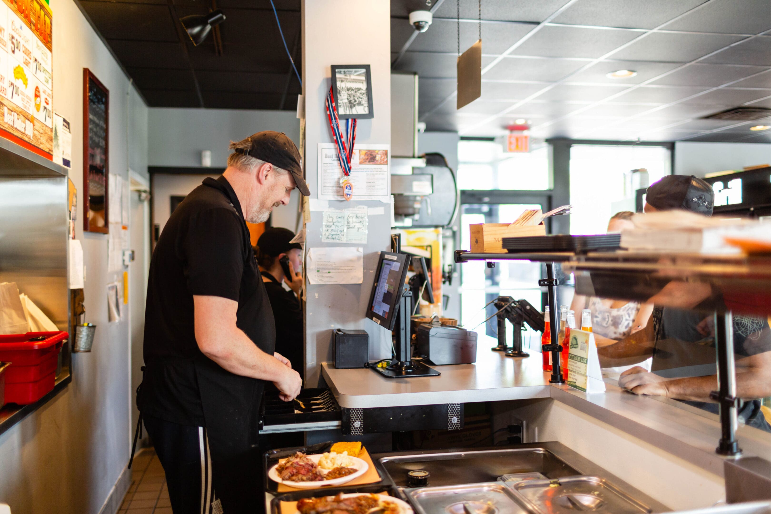 A man standing in front of an open kitchen.