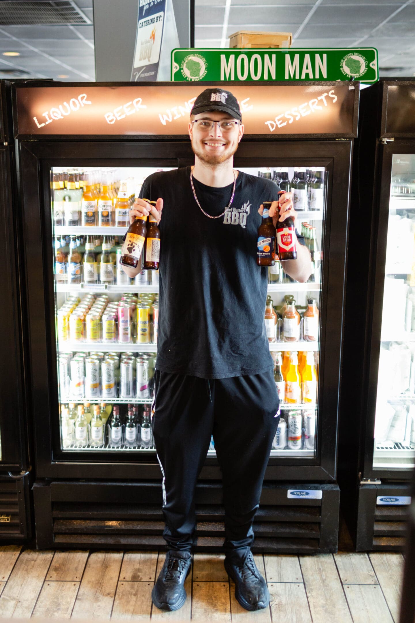 A man standing in front of an open refrigerator.