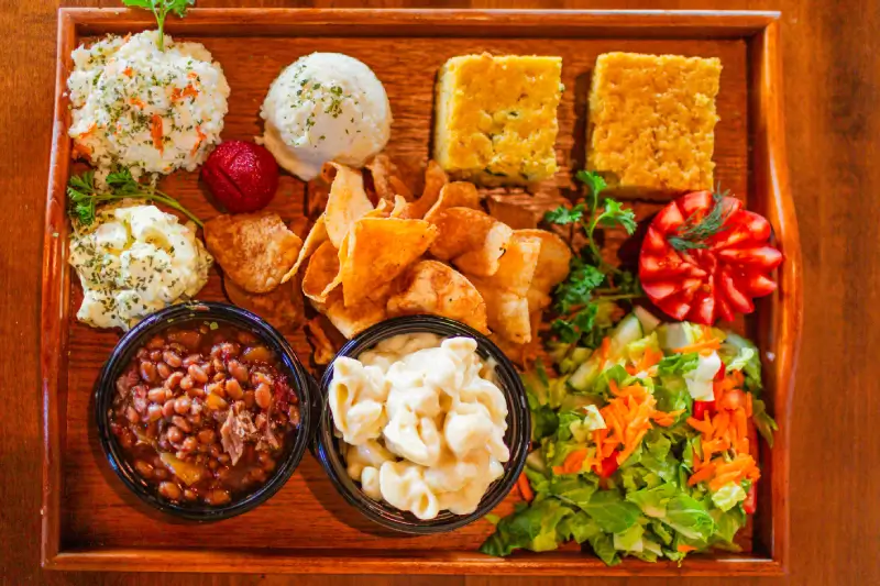 A wooden tray topped with bowls of food.