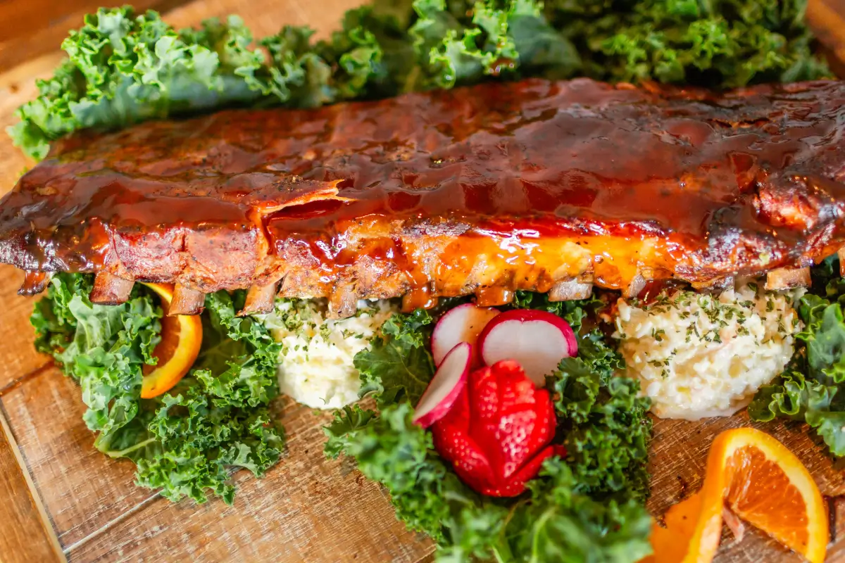 A close up of a plate with meat and vegetables