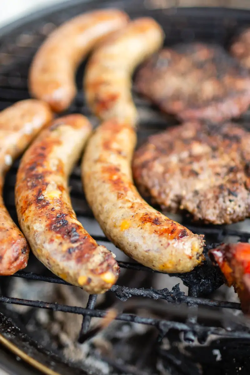 A grill with several different types of food on it.