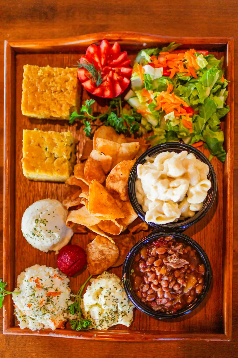 A wooden tray topped with different types of food.