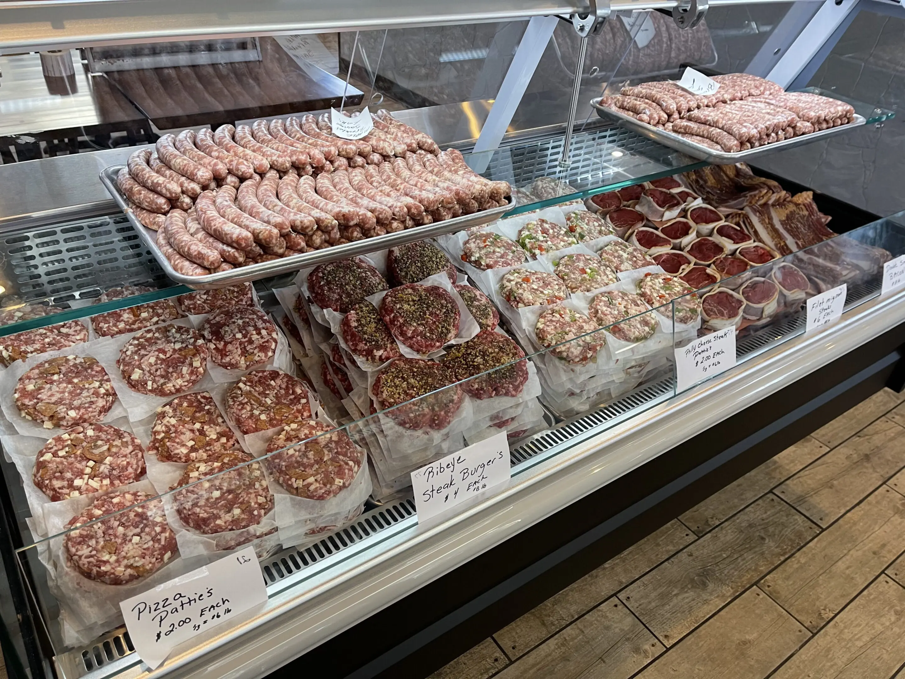 A display case filled with lots of different meats.