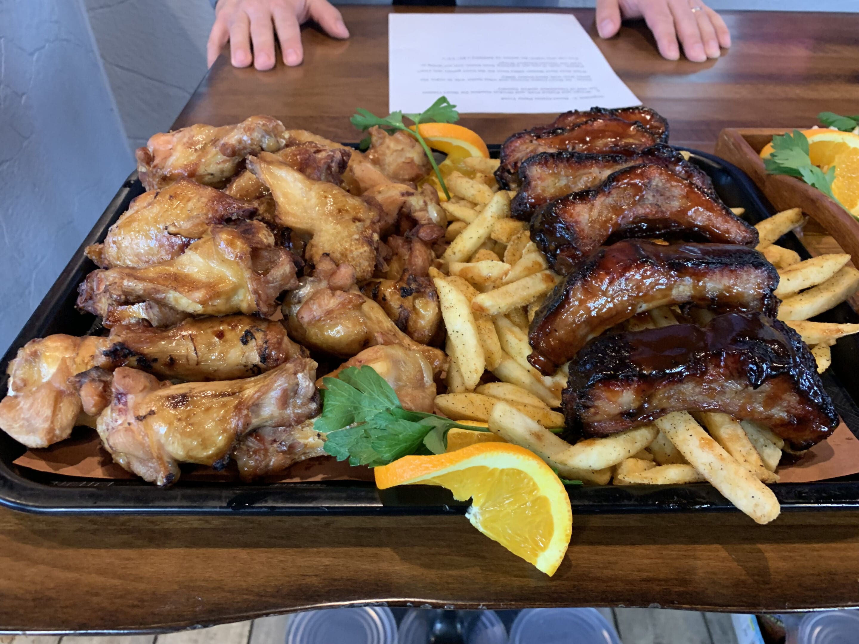 A tray of food with meat and french fries.