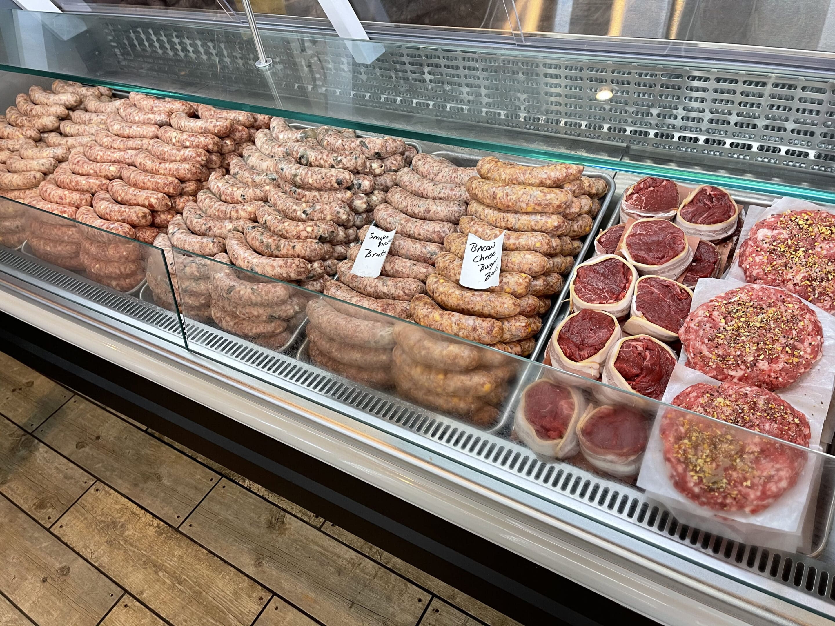 A display case filled with lots of different meats.